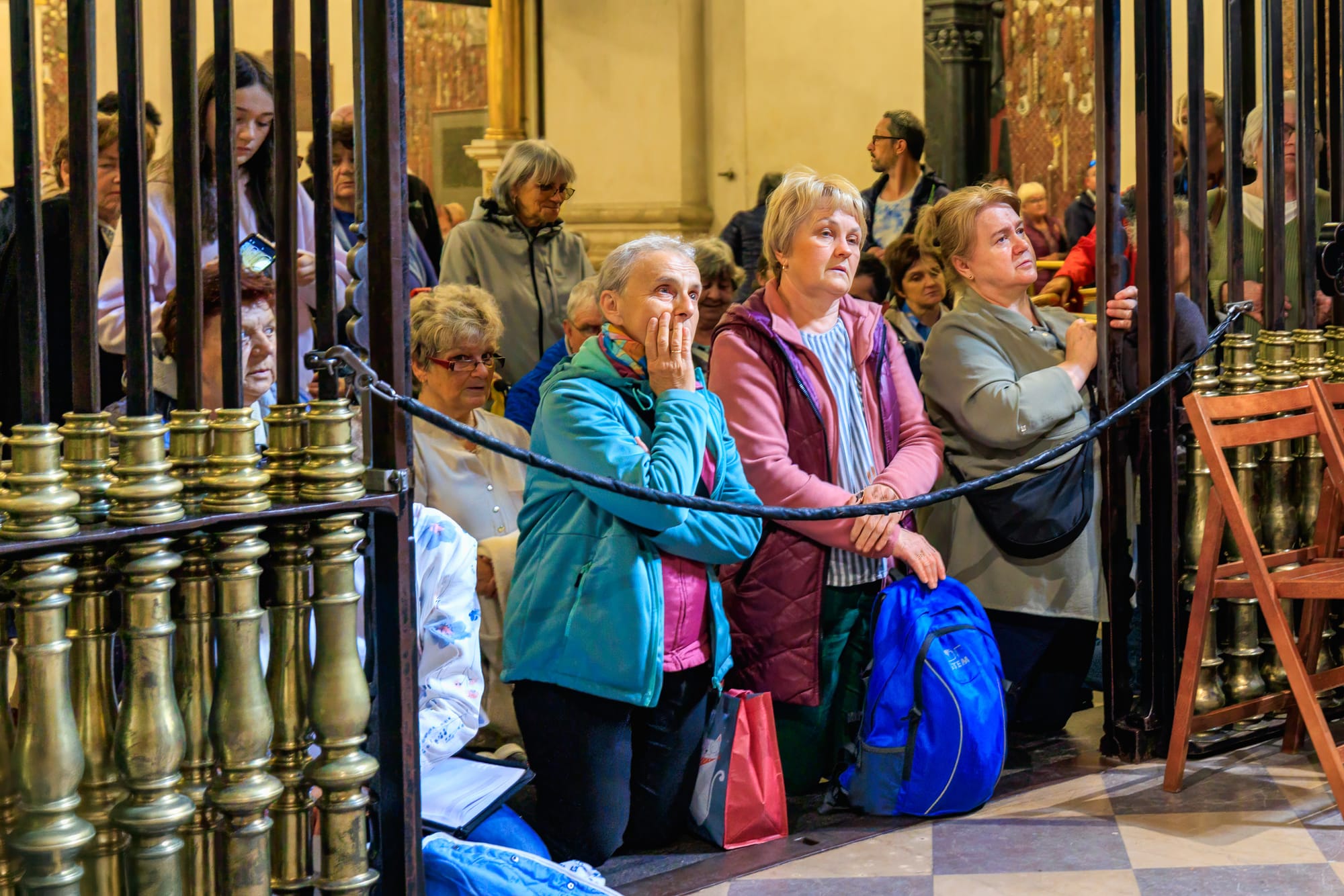 Pilgrims at Jasna Góra kneel in reverence before the Black Madonna.